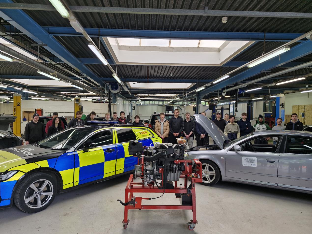 College students with donated cars from Dorset Police.jpg